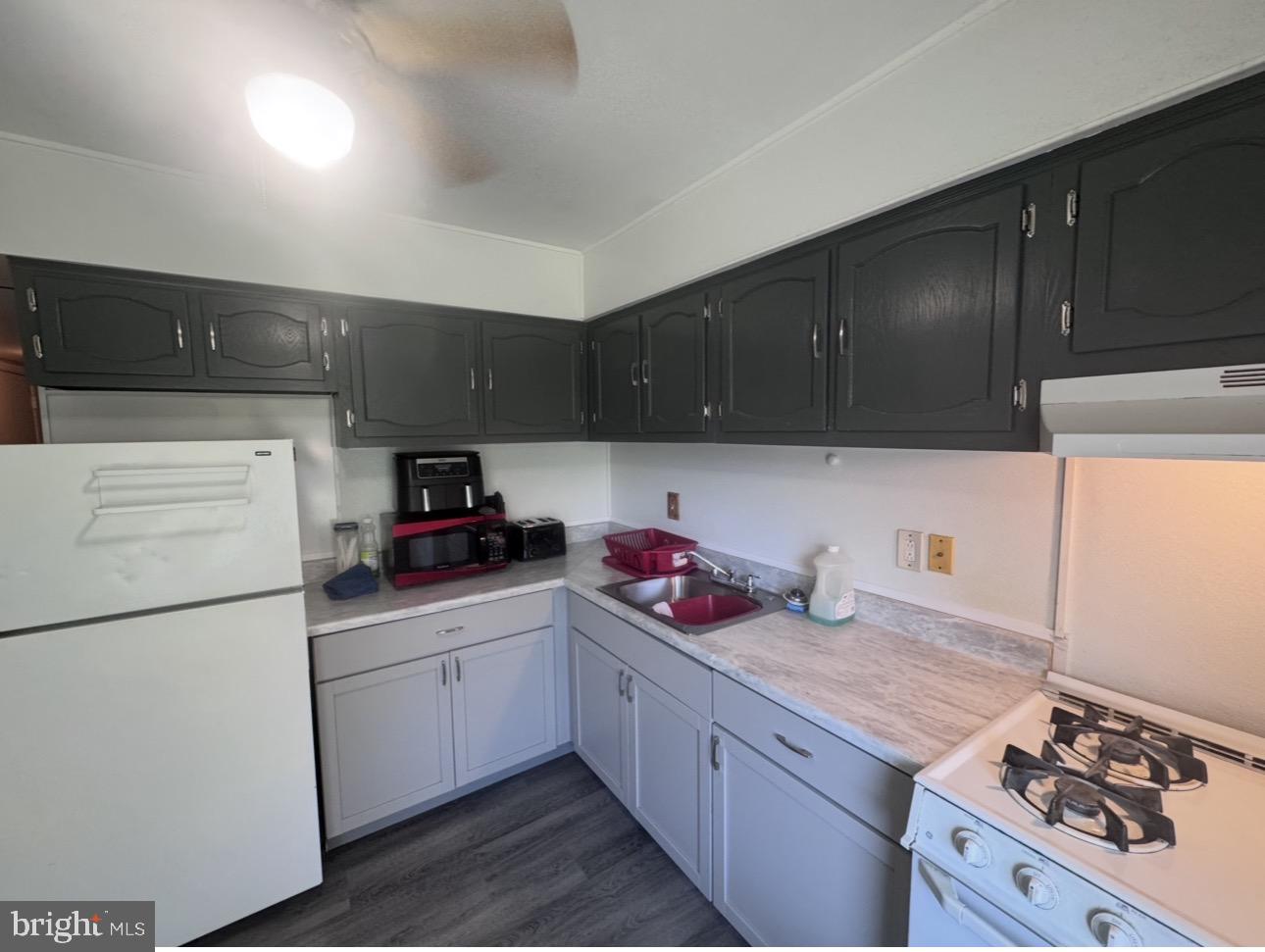 33 Chelsea Circle Clementon, NJ 08021 - Photo 4 of 6 a kitchen with a white cabinets and white appliances