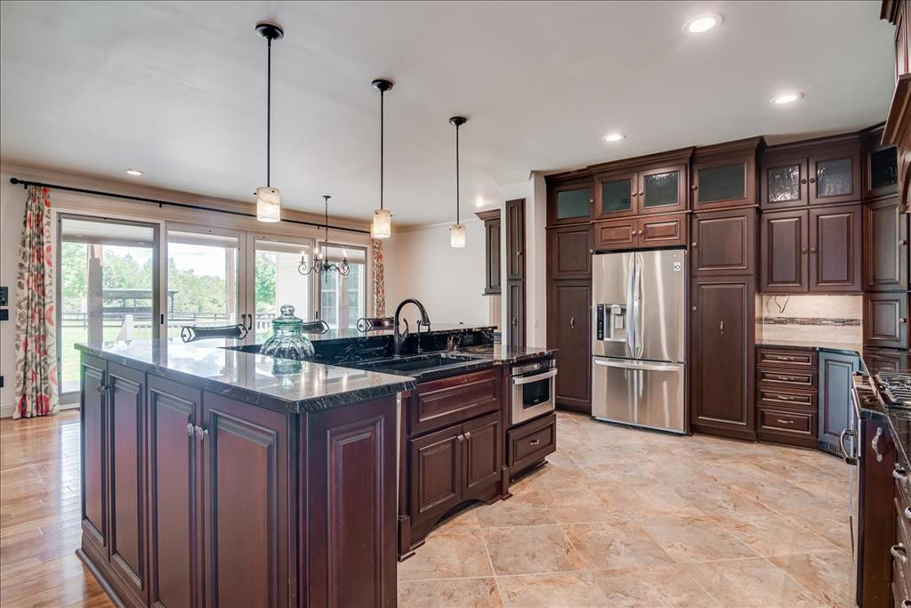 237 Implement Road Aiken, SC 29803 - Photo 7 of 43 a kitchen with stainless steel appliances granite countertop a sink refrigerator and cabinets