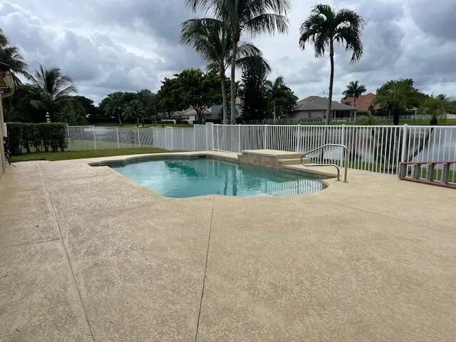 a view of outdoor space with swimming pool and seating