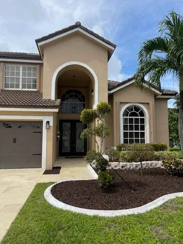 a front view of a house with garden