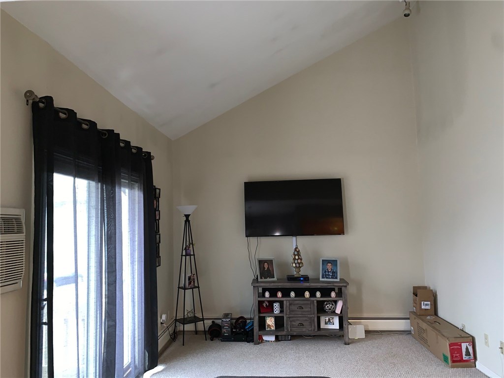 400 New River Road, Unit 305 Lincoln, RI 02838 - Photo 4 of 6 VAULTED CEILING IN LIVING ROOM WITH SLIDERS TO DECK