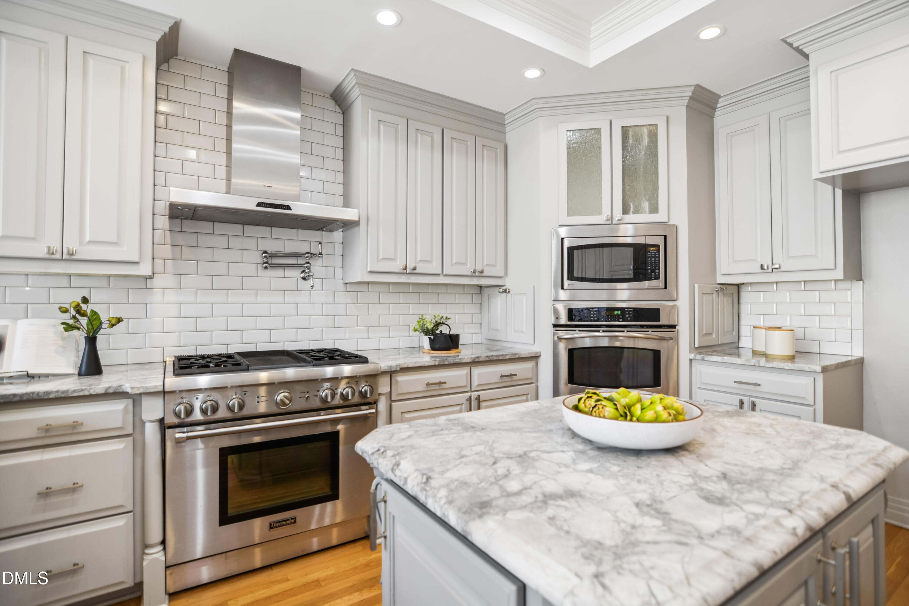 9933 Koupela Drive Raleigh, NC 27614 - Photo 18 of 59 a kitchen with a stove a sink and a microwave