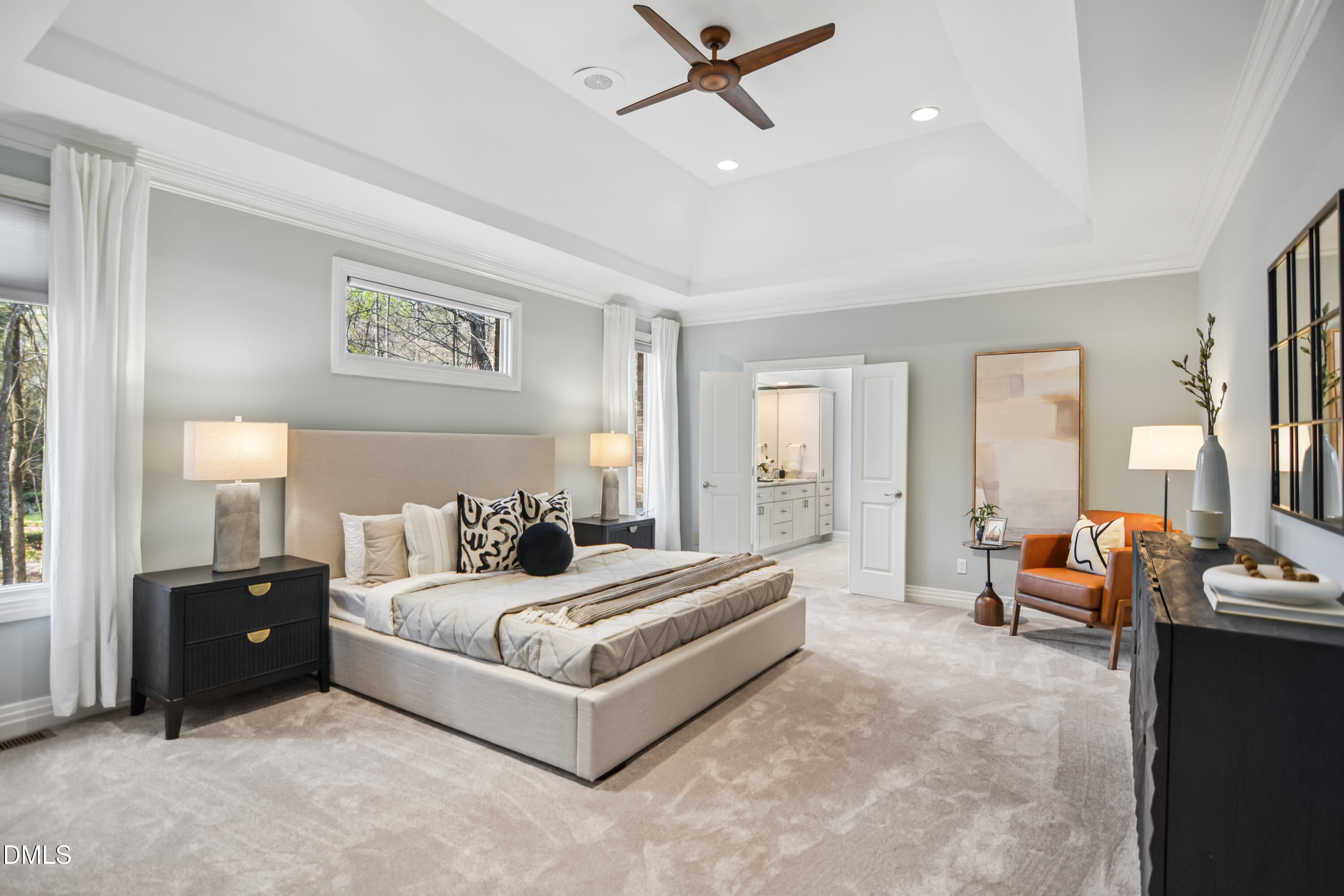 9933 Koupela Drive Raleigh, NC 27614 - Photo 22 of 59 a spacious bedroom with a bed a couch and a window