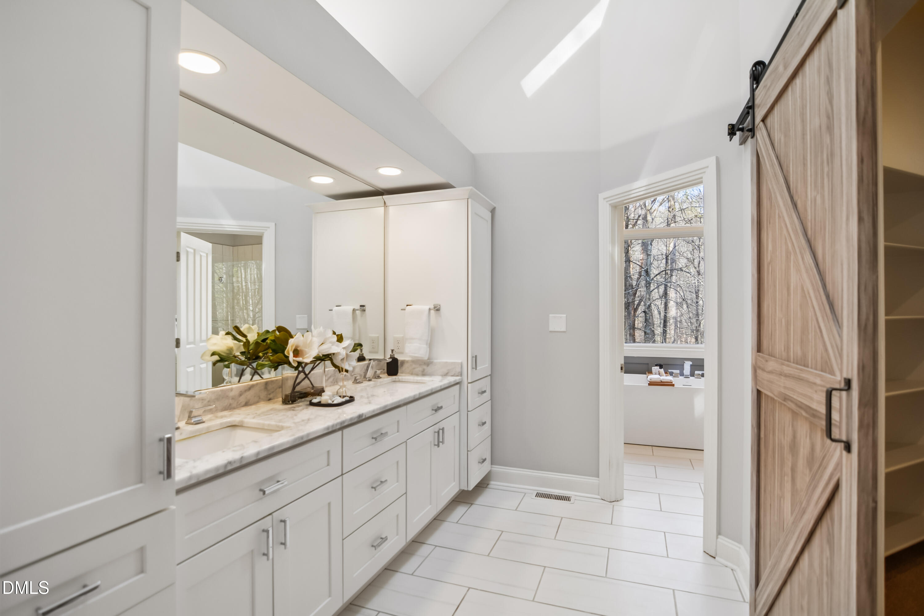9933 Koupela Drive Raleigh, NC 27614 - Photo 24 of 59 a spacious bathroom with a double vanity sink and a mirror