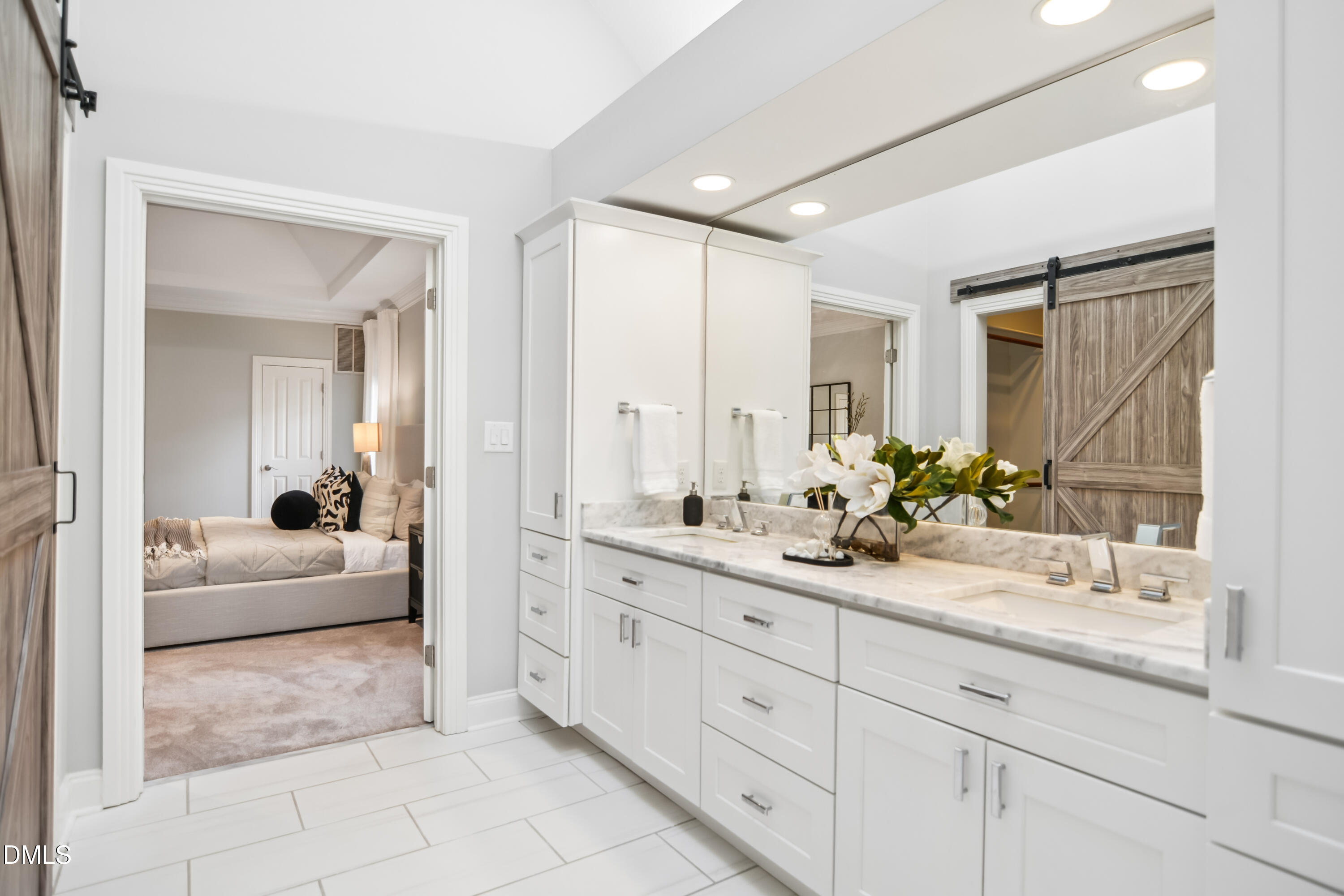 9933 Koupela Drive Raleigh, NC 27614 - Photo 25 of 59 a en suite bathroom with double sink and a mirror
