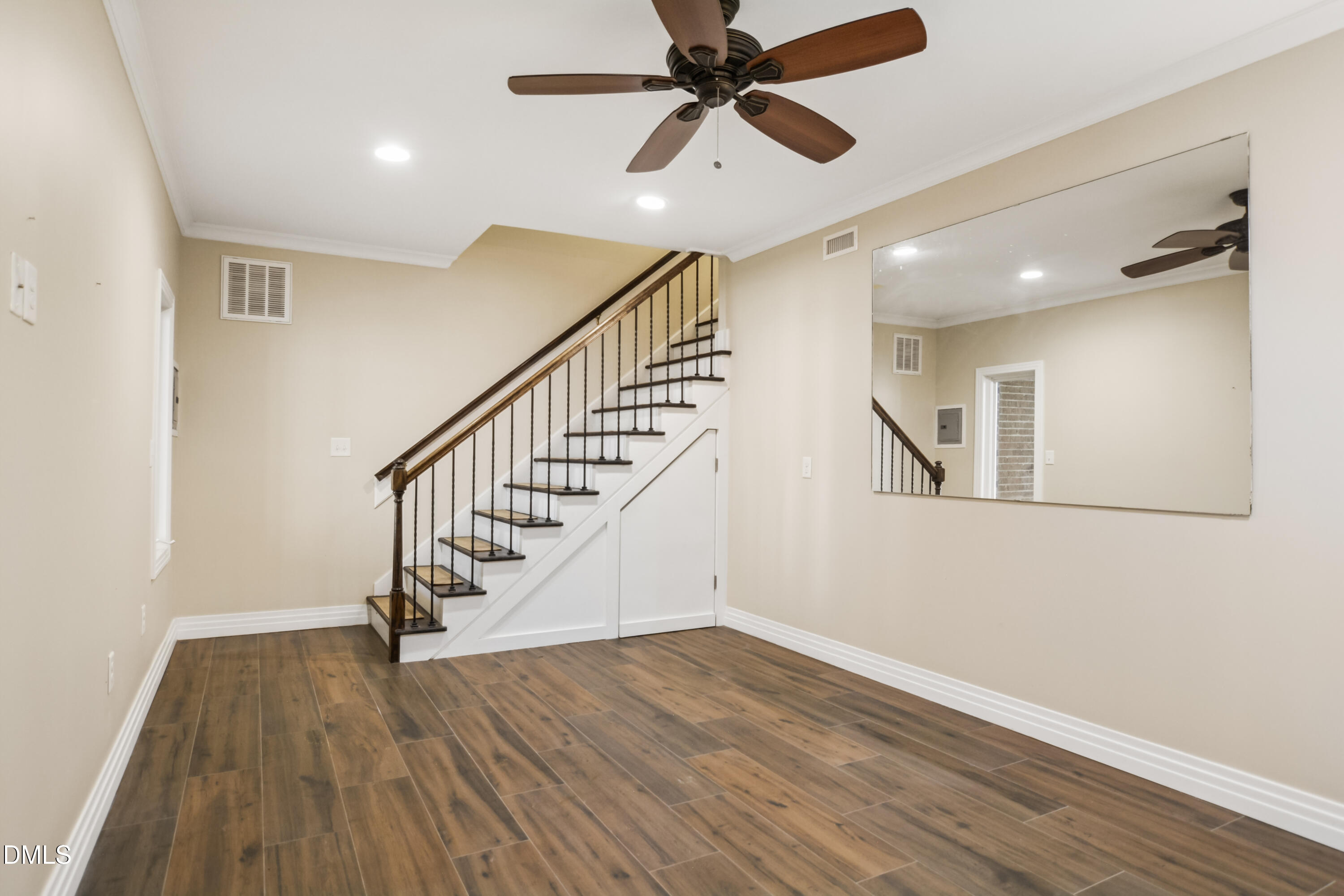 9933 Koupela Drive Raleigh, NC 27614 - Photo 44 of 59 a view of a hallway with wooden floor and staircase
