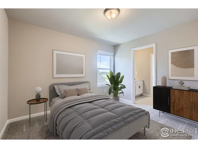 a bedroom with a bed and a potted plant