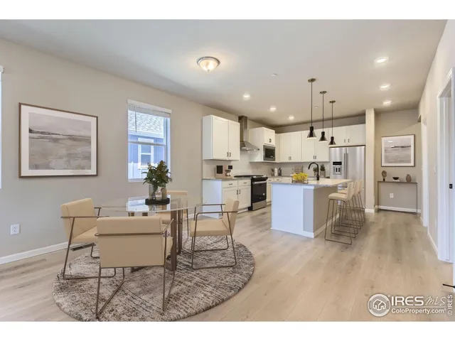 a kitchen with a table and chairs in it