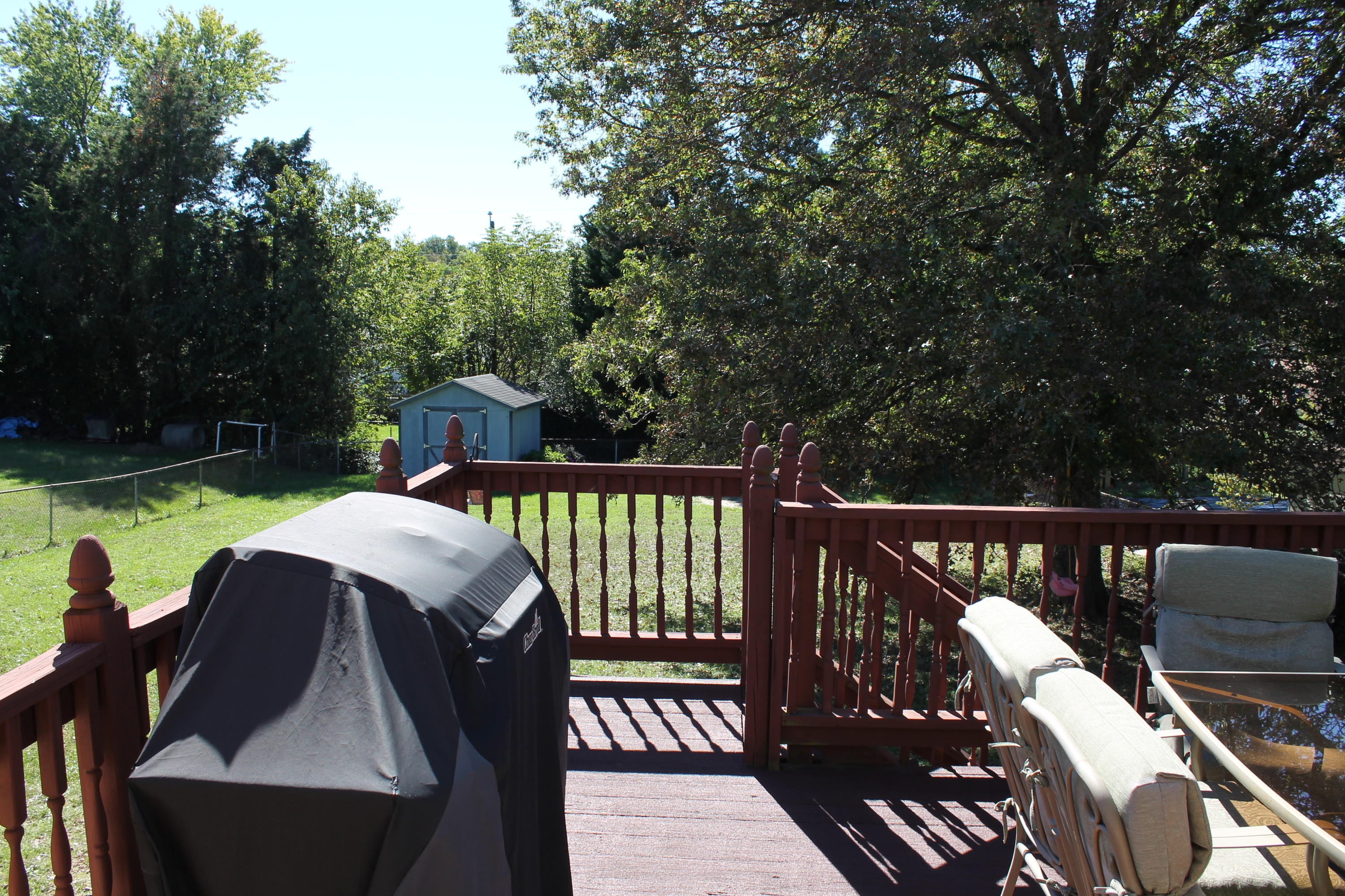 5706 Cove Road Roanoke, VA 24019 - Photo 22 of 65 a view of a patio with a table chairs and a fire pit