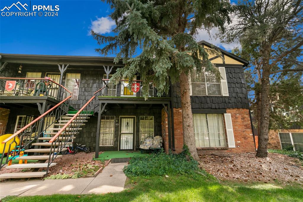 2902 Airport Road, Unit 215 Colorado Springs, CO 80910 - Photo 1 of 17 a front view of a house with a yard
