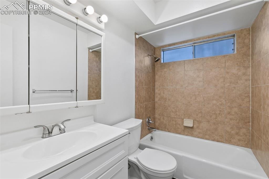 2902 Airport Road, Unit 215 Colorado Springs, CO 80910 - Photo 11 of 17 a bathroom with a sink a toilet and a bathtub