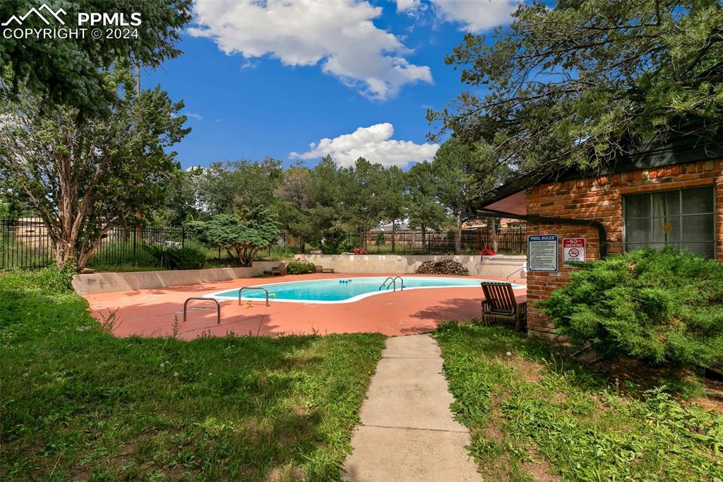 2902 Airport Road, Unit 215 Colorado Springs, CO 80910 - Photo 16 of 17 a view of a house with swimming pool and yard