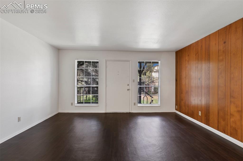 2902 Airport Road, Unit 215 Colorado Springs, CO 80910 - Photo 3 of 17 an empty room with wooden floor and windows