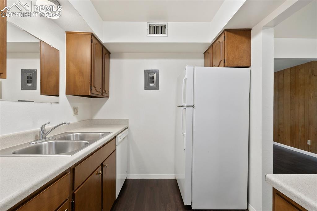 2902 Airport Road, Unit 215 Colorado Springs, CO 80910 - Photo 6 of 17 a kitchen that has a sink and a refrigerator