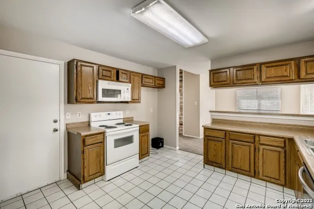 a kitchen with a stove sink and cabinets