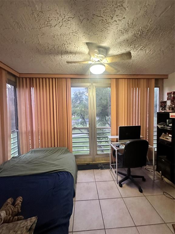 9531 Seagrape Drive, Unit 304 Davie, FL 33324 - Photo 11 of 11 a bedroom with a bed and large windows