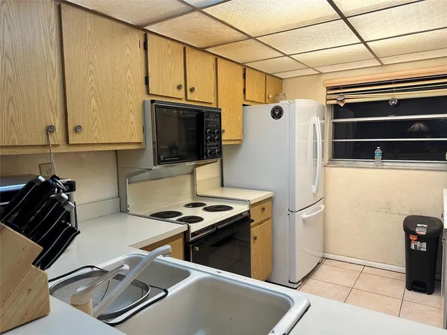 a kitchen with a refrigerator a stove top oven a sink and dishwasher