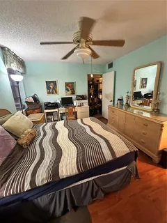 a bed room with furniture and a flat screen tv