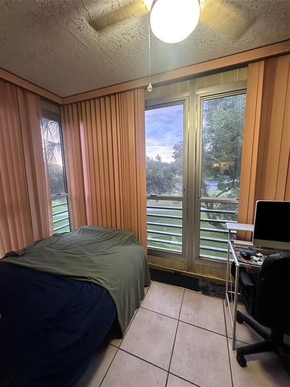 9531 Seagrape Drive, Unit 304 Davie, FL 33324 - Photo 9 of 11 a bedroom with a bed and a window