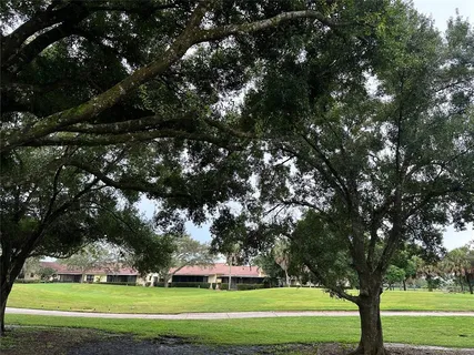 a bedroom with a bed and large windows