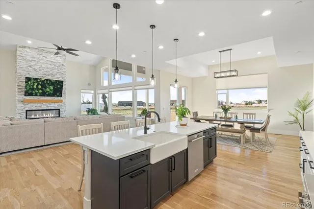 a kitchen with a stove a refrigerator a sink dishwasher with a dining table and chairs