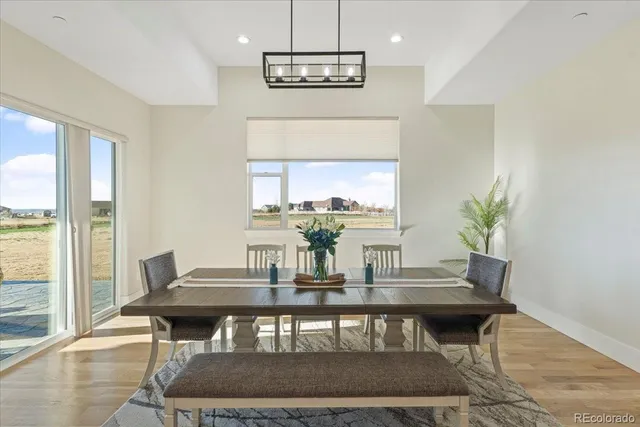 a view of a dining room with furniture window and wooden floor