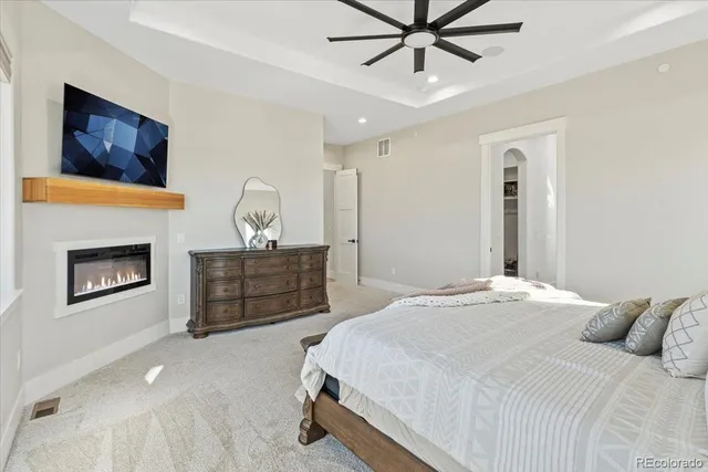 a bedroom with a bed and a fireplace