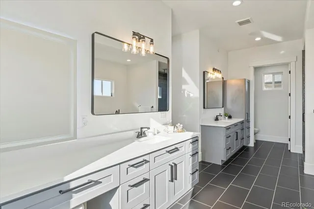 a bathroom with a double vanity sink mirror and