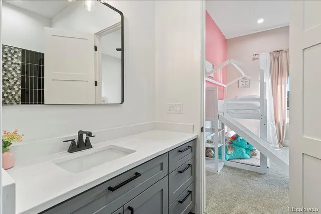 a bathroom with a sink a vanity and a mirror