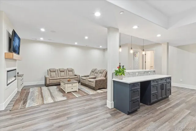 a large room with lots of counter space and painting on the wall