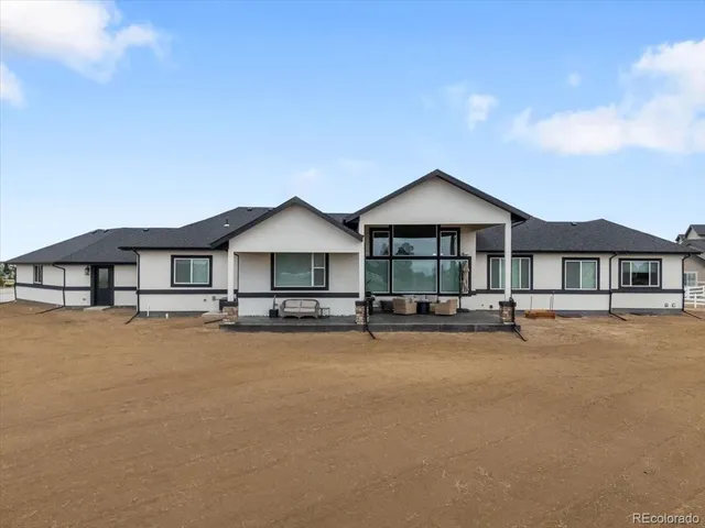 a front view of a house with yard and balcony