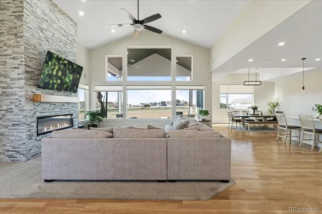 a living room with fireplace furniture and a large window