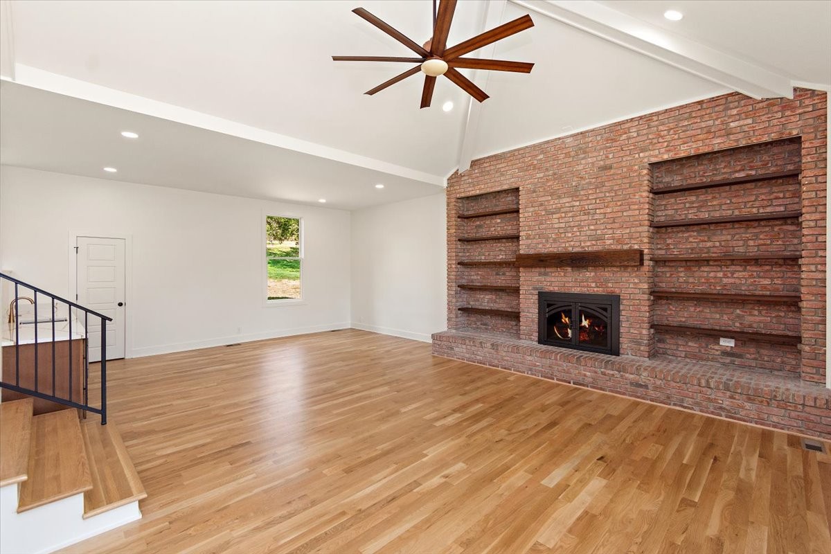 1409 Sneed Road West Franklin, TN 37069 - Photo 18 of 63 a view of an empty room with a fireplace and a window