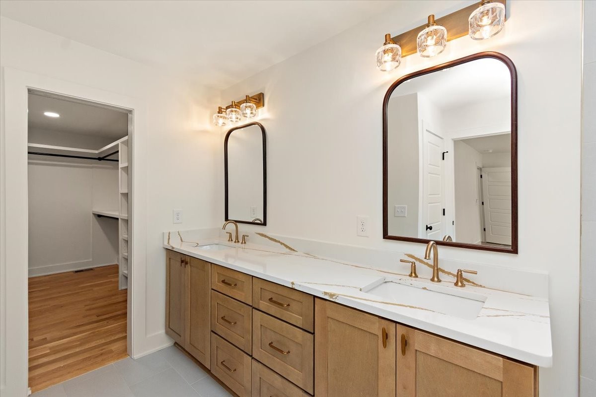 1409 Sneed Road West Franklin, TN 37069 - Photo 34 of 63 a bathroom with a double vanity sink and a mirror