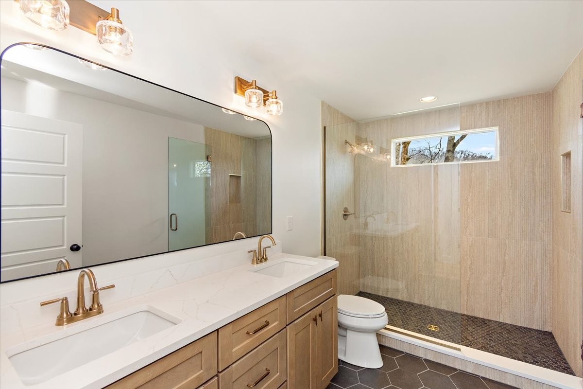 1409 Sneed Road West Franklin, TN 37069 - Photo 38 of 63 a bathroom with a double vanity sink toilet and shower