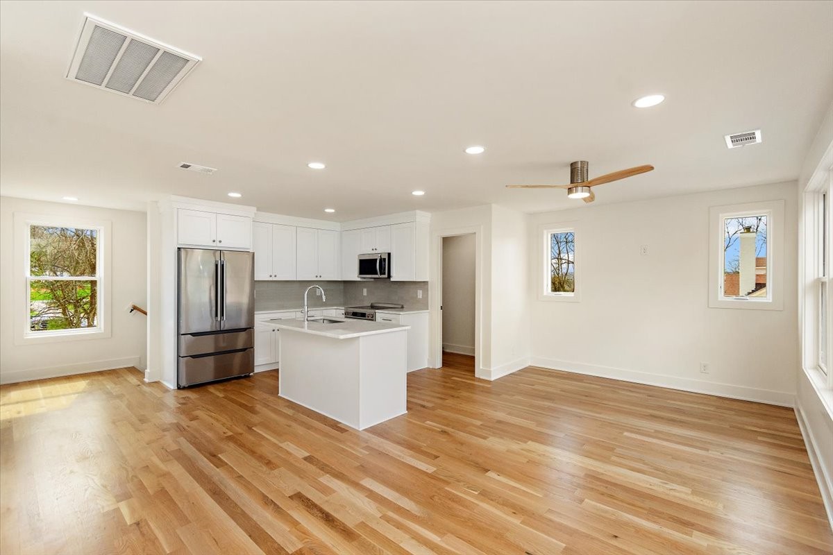 1409 Sneed Road West Franklin, TN 37069 - Photo 51 of 63 a kitchen with stainless steel appliances kitchen island a refrigerator sink and stove