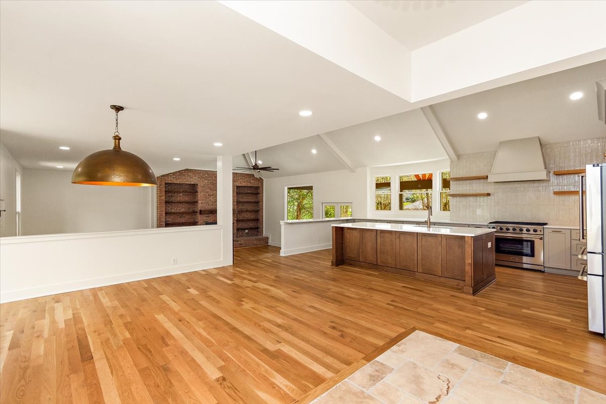 1409 Sneed Road West Franklin, TN 37069 - Photo 7 of 63 a large kitchen with stainless steel appliances kitchen island a large counter top a stove and a wooden floors