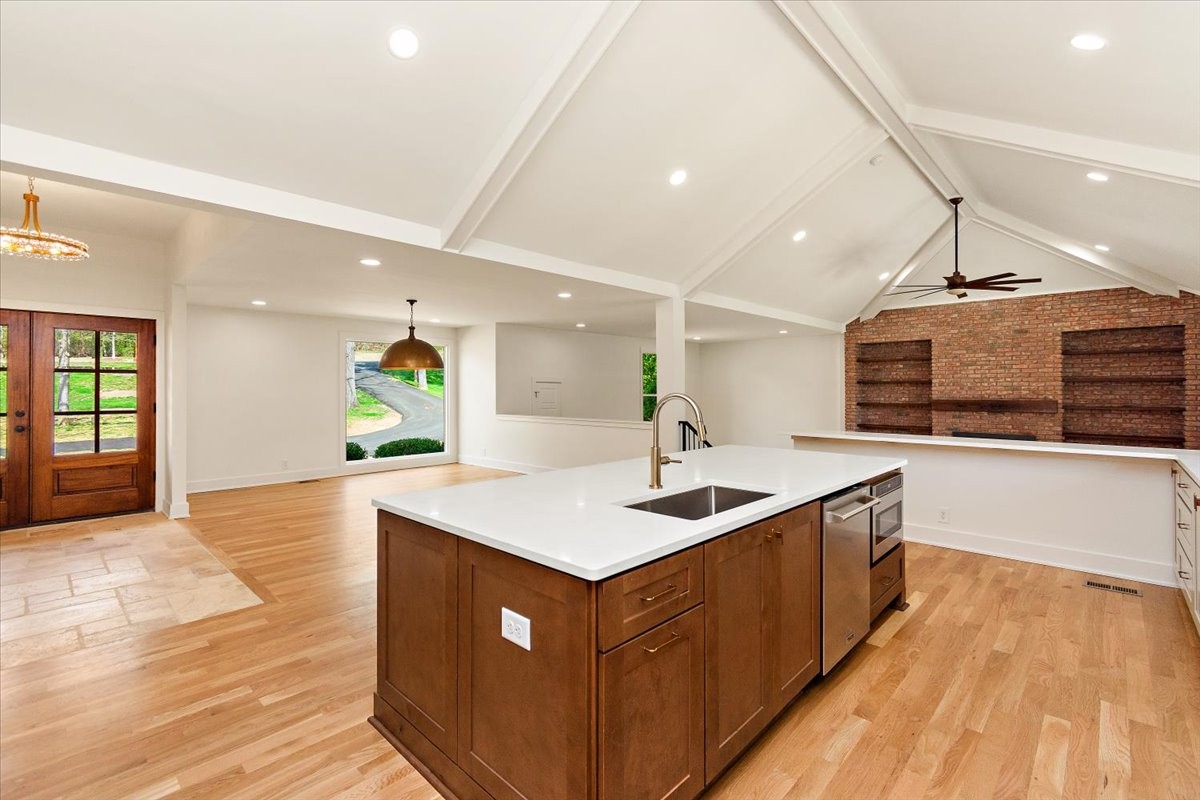 1409 Sneed Road West Franklin, TN 37069 - Photo 8 of 63 a kitchen with stainless steel appliances granite countertop a sink and a wooden floors
