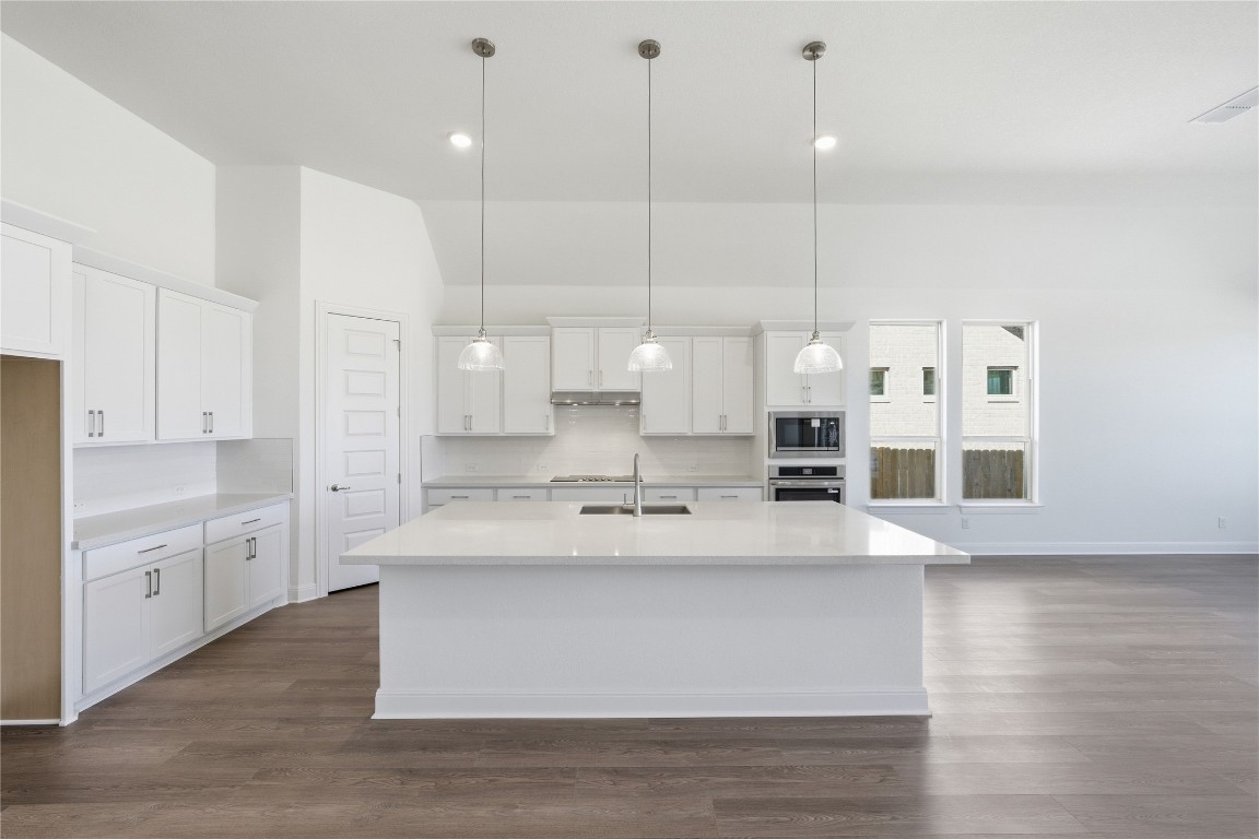 1208 Terrace View Drive Georgetown, TX 78628 - Photo 3 of 15 a large white kitchen with kitchen island a sink appliances and a counter space