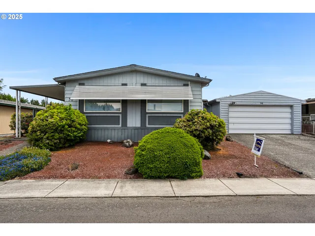 a front view of a house with a yard and a garage