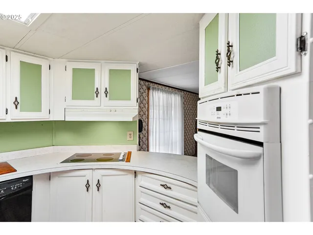 a kitchen with a sink cabinets and stainless steel appliances