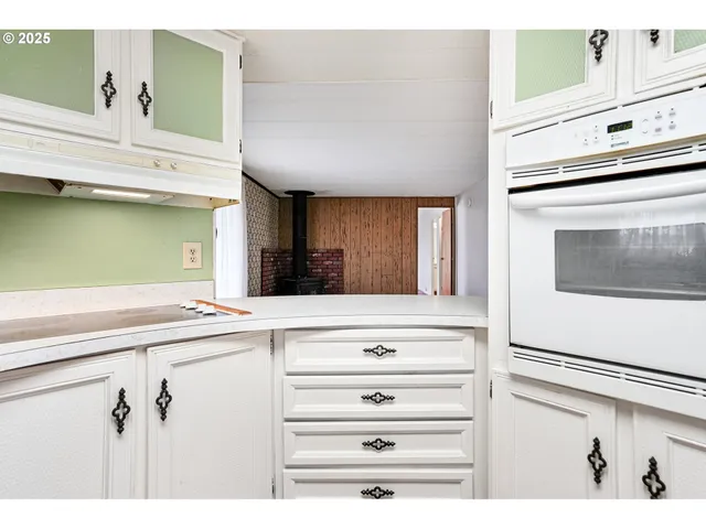 a view of kitchen with cabinets and wooden floor