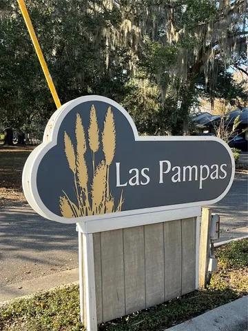 a view of sign board with a street