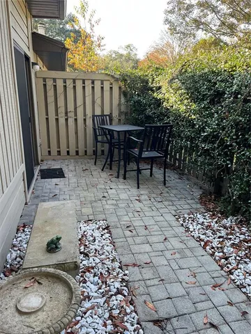 a backyard of a house with table and chairs