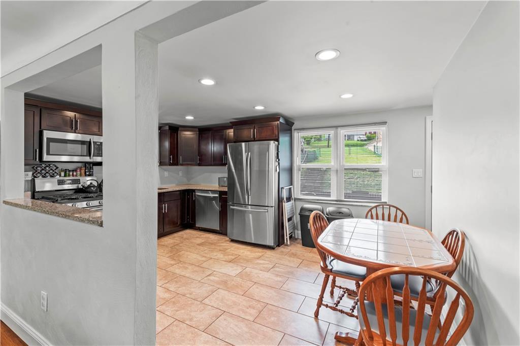 1962 Homestead Duquesne Road West Mifflin, PA 15122 - Photo 5 of 30 Large eat-in kitchen is sure to impress with stainless steel appliances, rich mocha cabinetry, and quartz countertops.