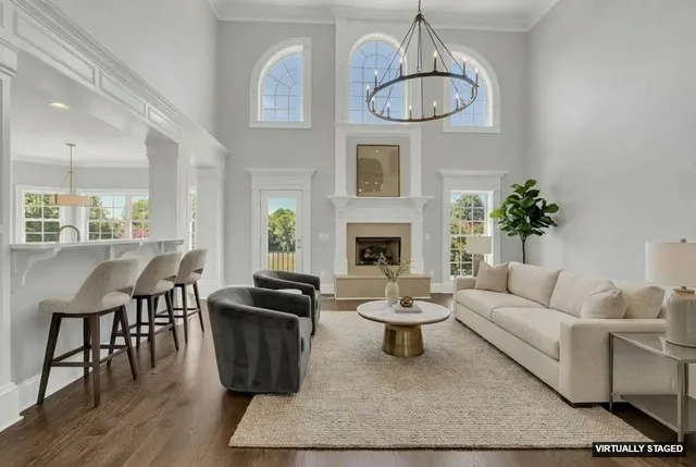 a living room with furniture a dining table and a fireplace