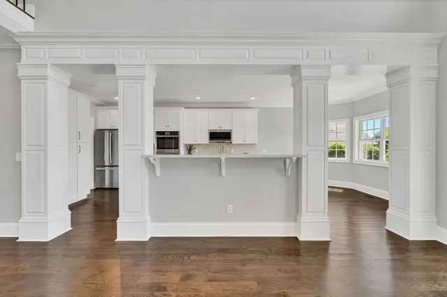 a view of a kitchen with an empty space and a window