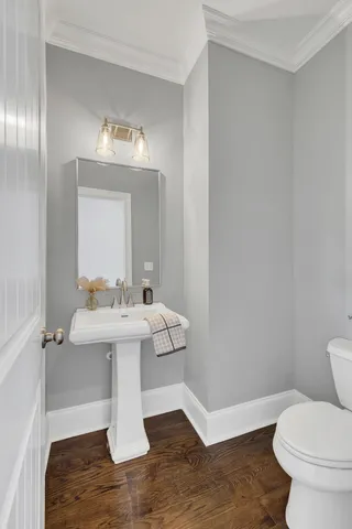 a bathroom with a sink toilet and a mirror
