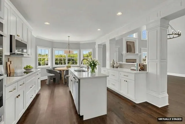 a kitchen with counter top space sink and wooden floor