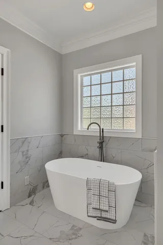 a white bath tub sitting in a bathroom